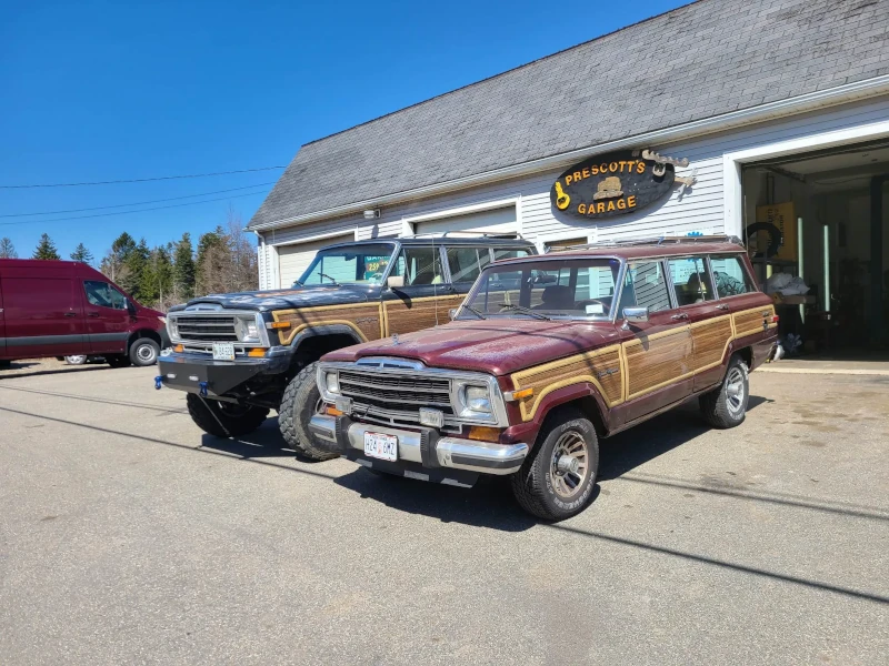 Two Jeep Grand Wagoneers, parked next to one another